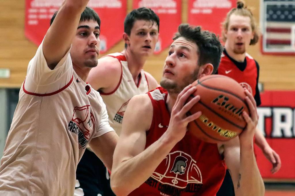 Everett Community Colleges Cameron Underwood (right) works with his back to the basket during the Trojans team practice Monday at Walt Price Student Fitness Center in Everett. (Kevin Clark / The Herald)