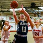 Arlingtons Makenzie Gage attempts a shot with Snohomishs Kinslee Gallatin (left) and Kaylin Beckman defending during a game on Feb. 6 in Snohomish. Arlington won 46-35. (Kevin Clark / The Herald)