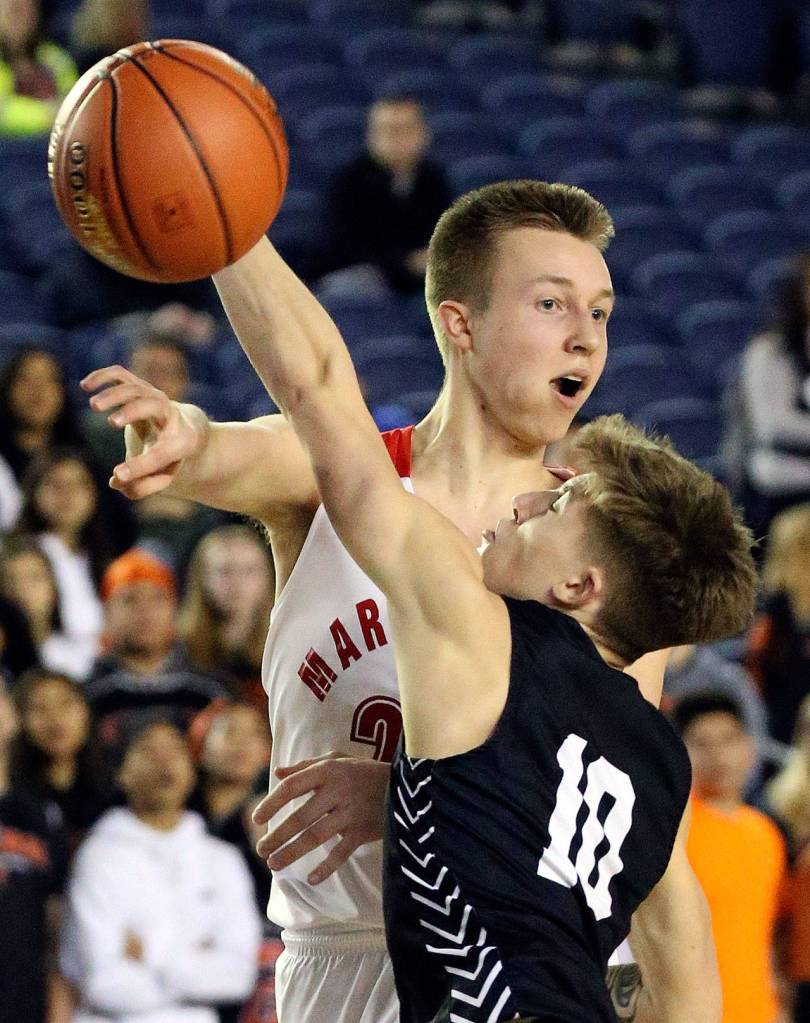 Marysville Pilchucks Luke Dobler makes a pass with Central Kitsaps Colby White defending during a 3A boys Hardwood Classic game Wednesday morning at the Tacoma Dome. (Kevin Clark / The Herald)