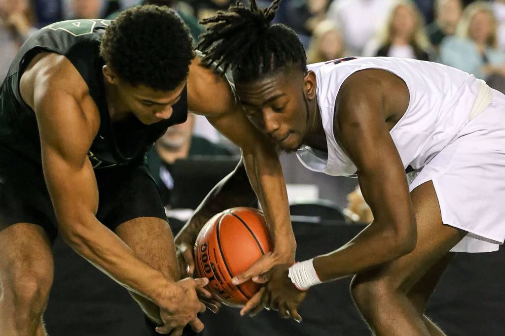 Marysville-Getchells Malakhi Knight (left) and Wilsons Emani Mithcell struggle for a loose ball Wednesday morning at the Tacoma Dome on March 4, 2020. Marysville-Gethchell lost to Wilson 73-52. (Kevin Clark / The Herald)