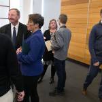 After a news conference, where officials issued new recommendations for limiting the spread of the COVID-19 virus, Snohomish County Emergency Management Director Jason Biermann and City of Monroe Public Works Director Brad Fielberg touch elbows before leaving the room on Thursday in Everett. (Andy Bronson / The Herald)