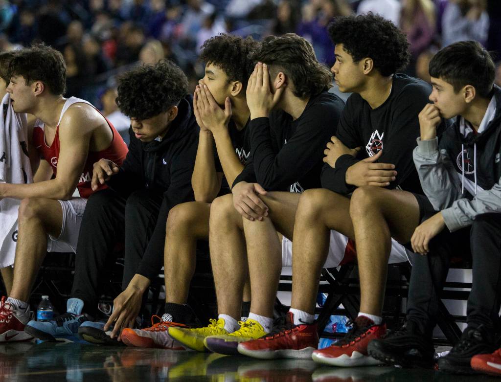 The Marysville Pilchuck bench watches the action during a 3A boys Hardwood Classic quarterfinal against Garfield on Thursday in Tacoma. (Olivia Vanni / The Herald)