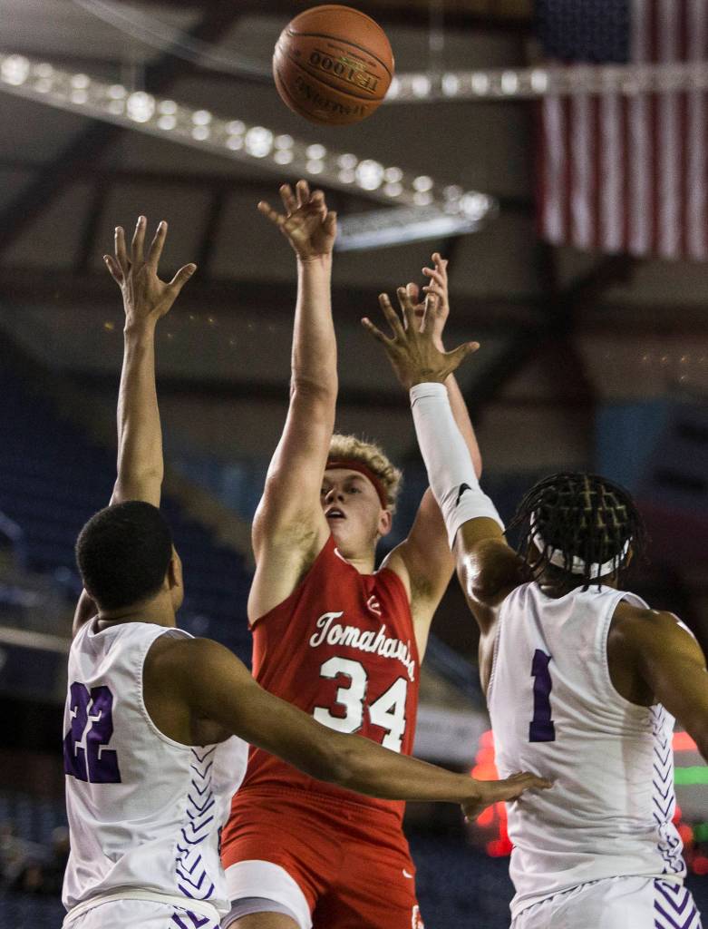 Marysville Pilchucks Cameron Stordahl attempts a shot while being guarded by Garfields Justin White and Kendall Munson during a 3A boys Hardwood Classic quarterfinal on Thursday in Tacoma. (Olivia Vanni / The Herald)