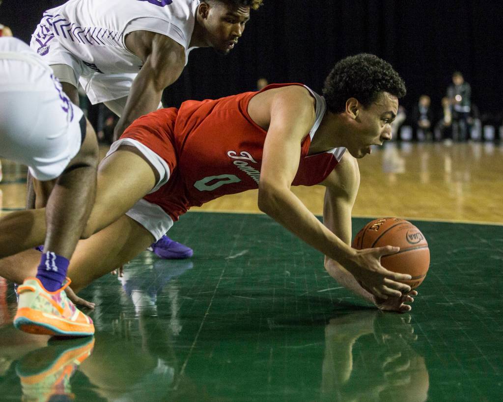 Marysville Pilchucks Ethan Jackson scrambles for the ball during a 3A boys Hardwood Classic quarterfinal against Garfield on Thursday in Tacoma. (Olivia Vanni / The Herald)