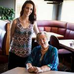 Pat Ward (seated) was featured in a 2017 Herald article about being rescued when she collapsed at an Everett restaurant. Here, she is shown with Heidi McCown, who administered CPR. Ward recently retired as a chaplain with the Mukilteo Police Department. (Ian Terry / Herald file)