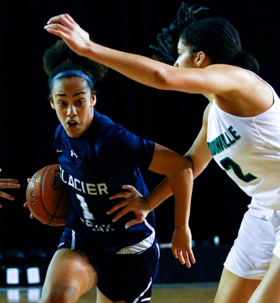 Glacier Peaks Aaliyah Collins drives the lane with Woodinvilles Veronica Sheffey defending during the semifinals Friday afternoon at the Tacoma Dome on March 6, 2020. Glacier Peak lost 63-41. (Kevin Clark / The Herald)