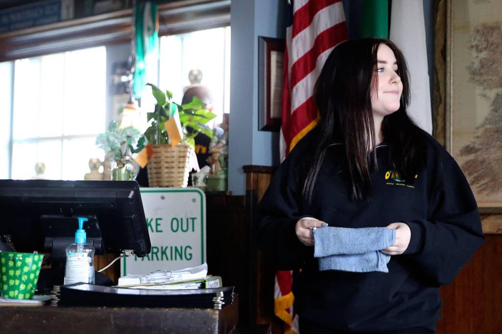Chloe Sharp awaits customers Saturday morning at Shawn ODonnells American Grill and Irish Pub, where an annual St. Patricks Day event has been greatly scaled back. (Kevin Clark / The Herald)