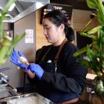 Seoul Hotdog co-owner Aram Han makes a Korean corn dog at the new shop in Lynnwood. (Kevin Clark / The Herald)