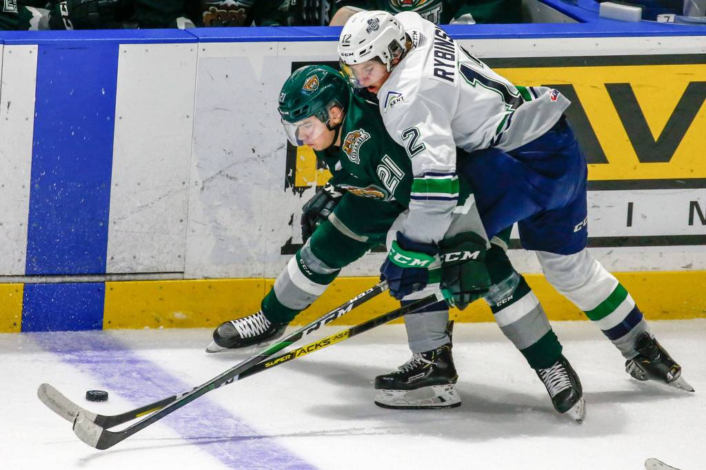 Everetts Dylan Anderson (left) fends off Seattles Simon Kubicek Sunday evening at ShoWare Center in Kent on March 8, 2020. The Silvertips won 3-2. (Kevin Clark / The Herald)