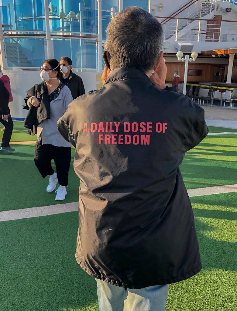 A man wears a jacket that says a daily dose of freedom on the Diamond Princess deck in an outdoor session during quarantine on Feb. 11. (Susan Anabel)