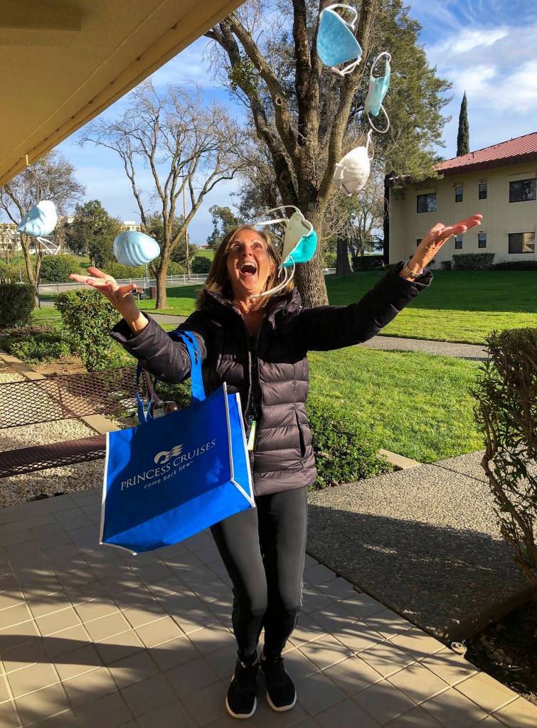Susan Anabel throws a handful of her surgical masks in the air on the day she was released to go home from Travis Air Force Base in California on March 2. (Susan Anabel)