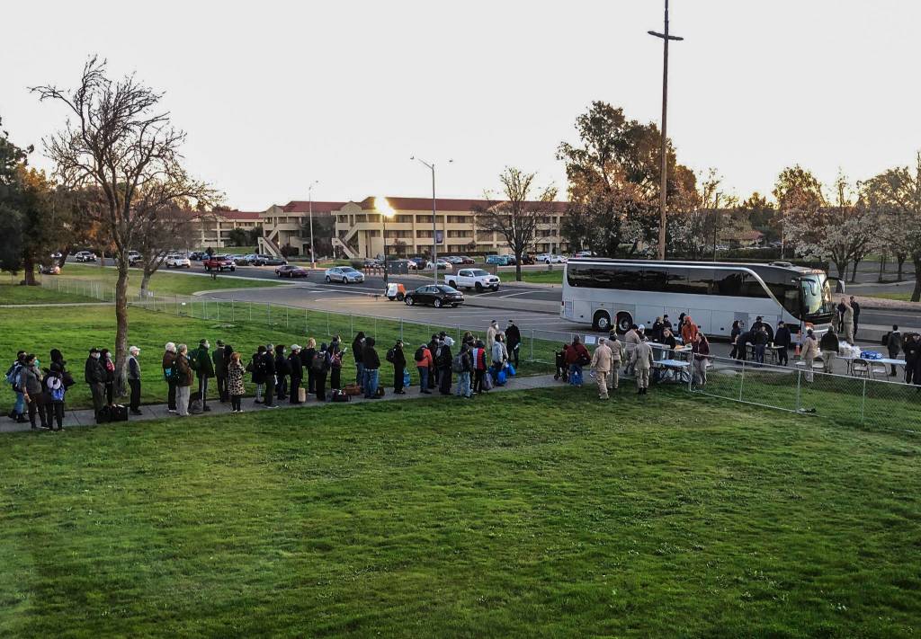 People were lined up waiting to get on buses to leave Travis Air Force Base on March 2 in California. (Susan Anabel)