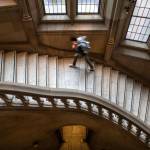 A student climbs a stairway at the University of Washingtons Suzzallo library on March 6, after in-person classes were cancelled due to coronavirus concerns. (Steve Ringman / The Seattle Times)