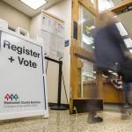 People walk in and out of the Snohomish County Auditors Office to drop off ballots and register to vote on Tuesday in Everett. (Olivia Vanni / The Herald)