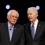 Democratic presidential candidates former Vice President Joe Biden (left) and Sen. Bernie Sanders talk before a Democratic presidential primary debate on Feb. 25 in Charleston, South Carolina. (AP Photo/Matt Rourke)