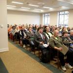 A Washington State Patrol trooper stands watch Feb. 25 as a capacity audience listens to testimony at a public hearing at the Capitol in Olympia on a new bill that would ban high-capacity gun magazines in Washington state. (AP Photo/Ted S. Warren, file)