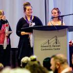 At the Cocoon House Butterfly Celebration in 2018, Jennifer McCabe (left) wipes a tear as her daughters Vanessa Bassi and Jayla Bassi speak to the crowd. The event has been canceled this year due to the coronavirus outbreak. (Dan Bates/ The Herald)