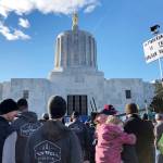 In this Feb. 6 photo, demonstrators protest against a cap-and-trade bill aimed at stemming global warming at the Oregon State Capitol in Salem. (AP Photo/Andrew Selsky, File)