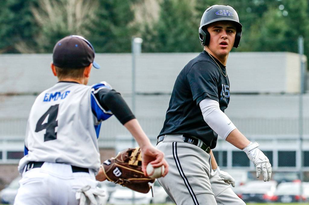 Meadowdales Cutter Buchea (right) is chased by third baseman Nick Emme during practice Thursday at Meadowdale High School in Lynnwood. (Kevin Clark / The Herald)
