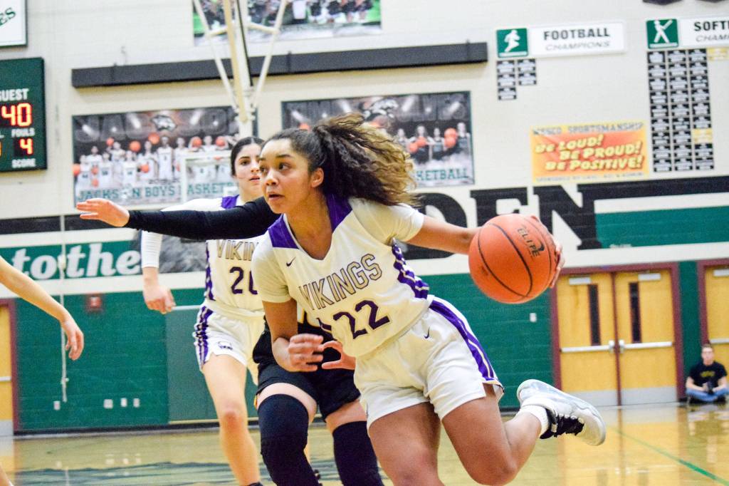 Lake Stevens senior Raigan Reed drives to the basket. (Katie Webber / The Herald)