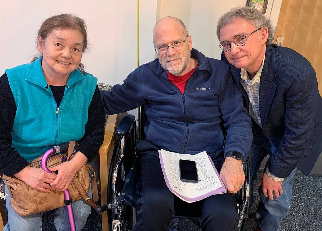 Yuki Tolmie, Stan Orchard and Doug Tolmie. Yuki Tolmie, 72, has been hospitalized at Providence Regional Medical Center Everett with a rare neuromuscular disease since Feb. 22. Her family wasnt allowed to see her for two days because of coronavirus concerns. (Courtesy of Doug Tolmie)