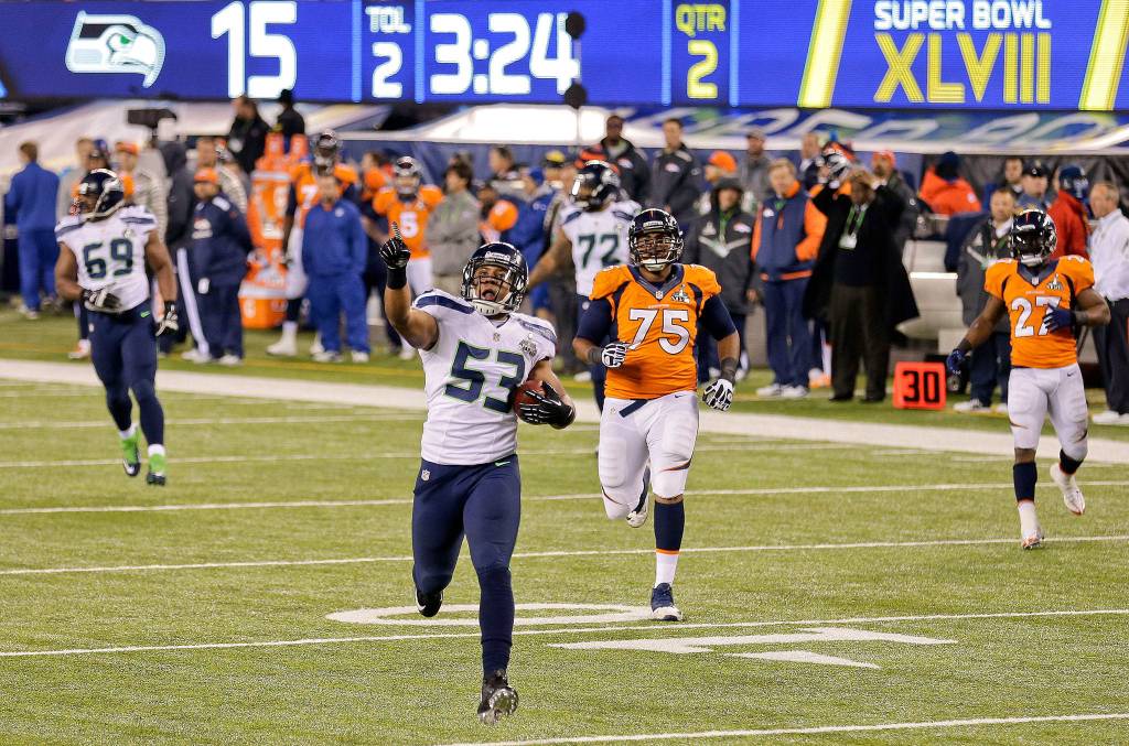 Seahawks linebacker Malcolm Smith (53) returns an interception for a touchdown against the Denver Broncos during the first half Super Bowl XLVIII in 2014 in East Rutherford, N.J. (AP Photo/Gregory Bull, File)