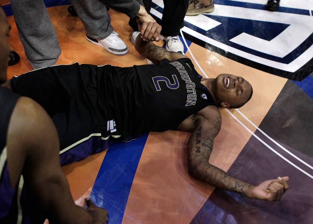 Washington guard Isaiah Thomas lies on the court while celebrating the teams 77-75 win over Arizona in the Pac-10 conference championship game in 2011 in Los Angeles. (AP Photo/Jae C. Hong)