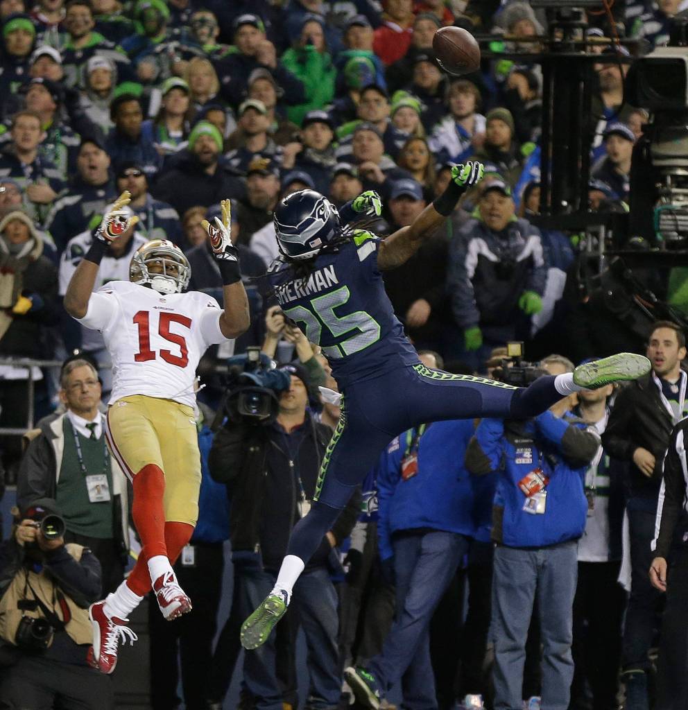 The Seahawks Richard Sherman tips a pass intended for the 49ers Michael Crabtree (15) in the final seconds of the 2014 NFC Championship game in Seattle. Malcolm Smith intercepted the tipped pass and the Seahawks won 23-17 to advance to Super Bowl XLVIII. (AP Photo/Marcio Jose Sanchez)