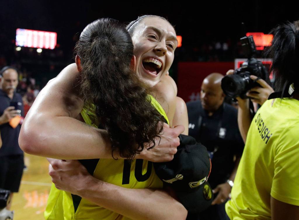 Storm forward Breanna Stewart (rear) hugs teammate Sue Bird on the court after beating the Mystics in Game 3 of the WNBA Finals in 2018 in Fairfax, Va. (AP Photo/Carolyn Kaster)