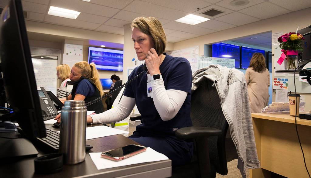 Registered Nurse Andrea Rairdin takes and makes call at the Command Center in Providence Regional Medical Center on Friday, March 20, 2020 in Everett, Wa.(Andy Bronson / The Herald)