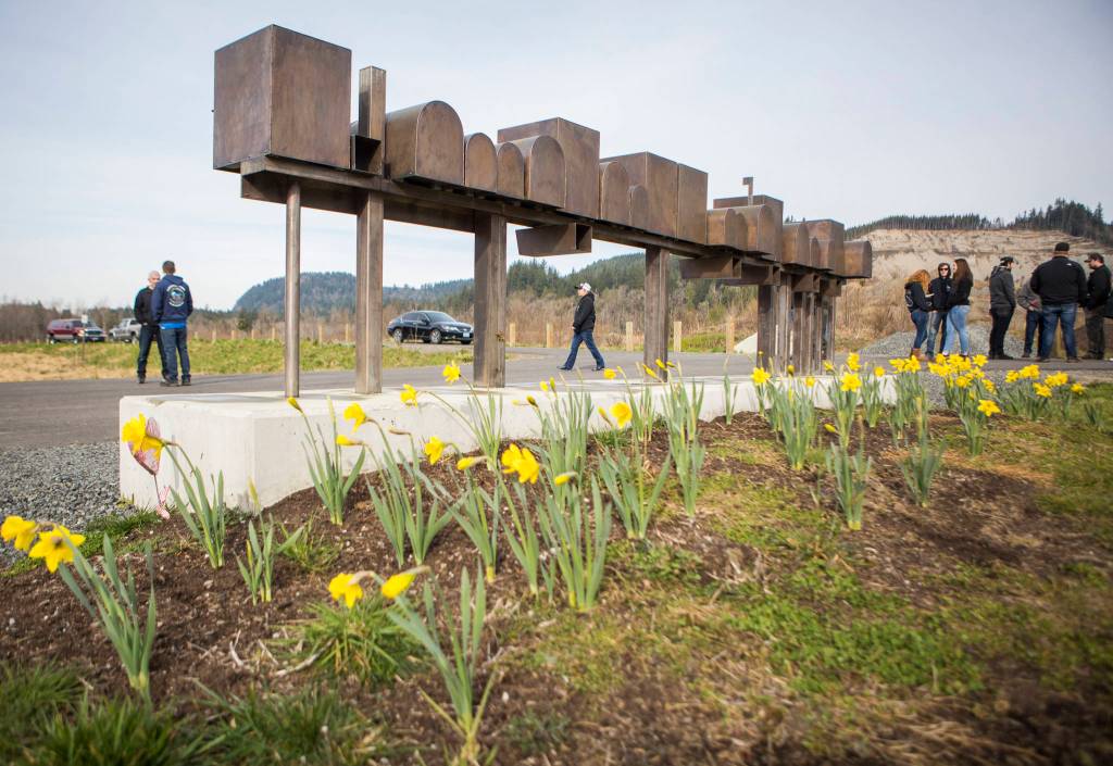 People begin to gather at the Oso slide site on Sunday near Oso. (Olivia Vanni / The Herald)