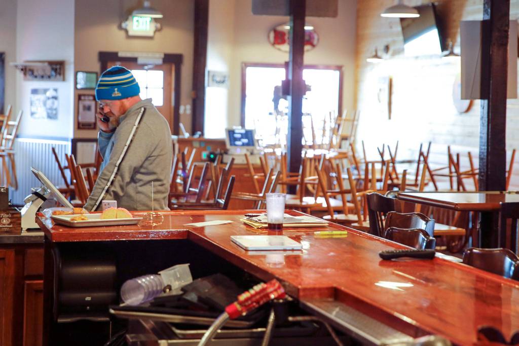 David Smithburg takes an order over the phone for pick-up at The Amarillo in Monroe on March 20. (Kevin Clark / The Herald)