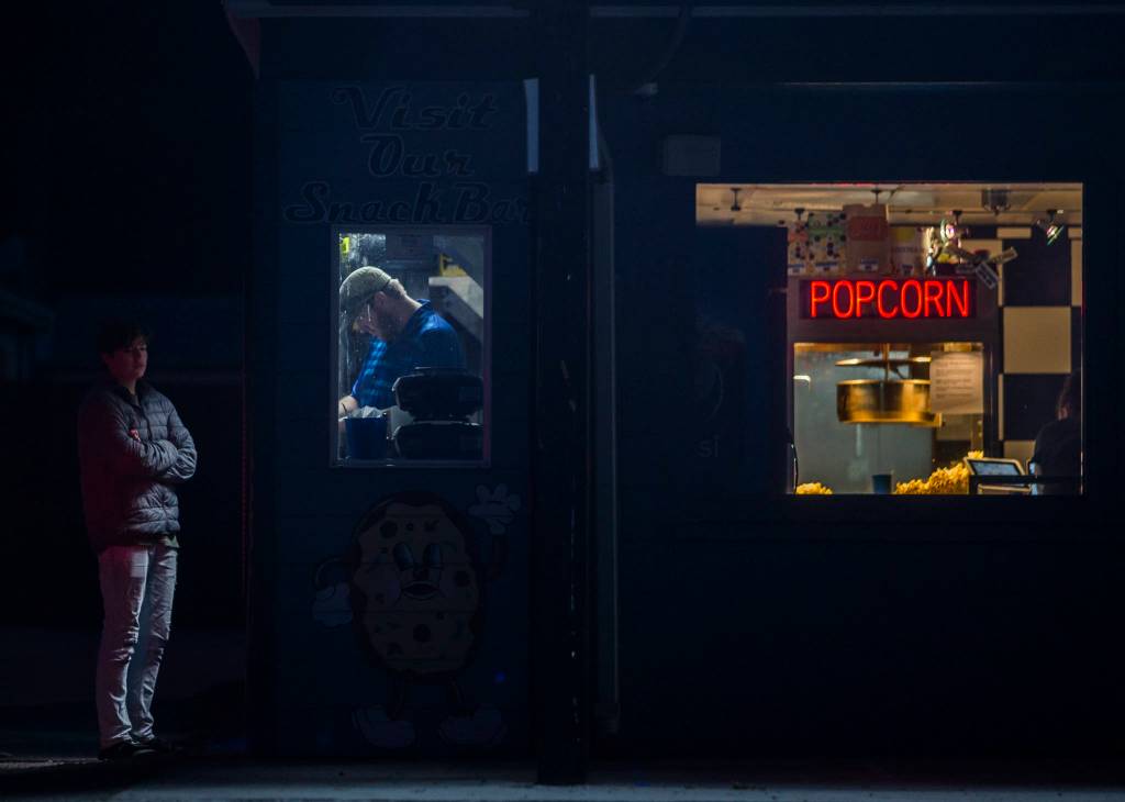 Lights illuminate the ticket booth and concession stand at Blue Fox Drive-In on Thursday in Oak Harbor. (Olivia Vanni / The Herald)