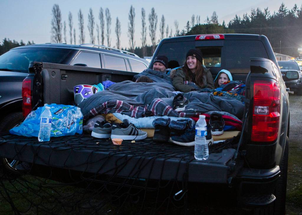 The Davis family from Lake Stevens sit together in their trucked as they wait for the movie to start on Thursday. (Olivia Vanni / The Herald)