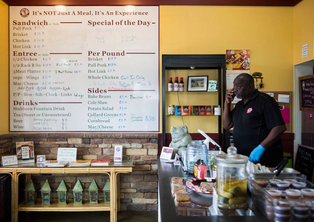 Carolina Smoke owner David Hayward takes an order over the phone Sunday. (Olivia Vanni / The Herald)