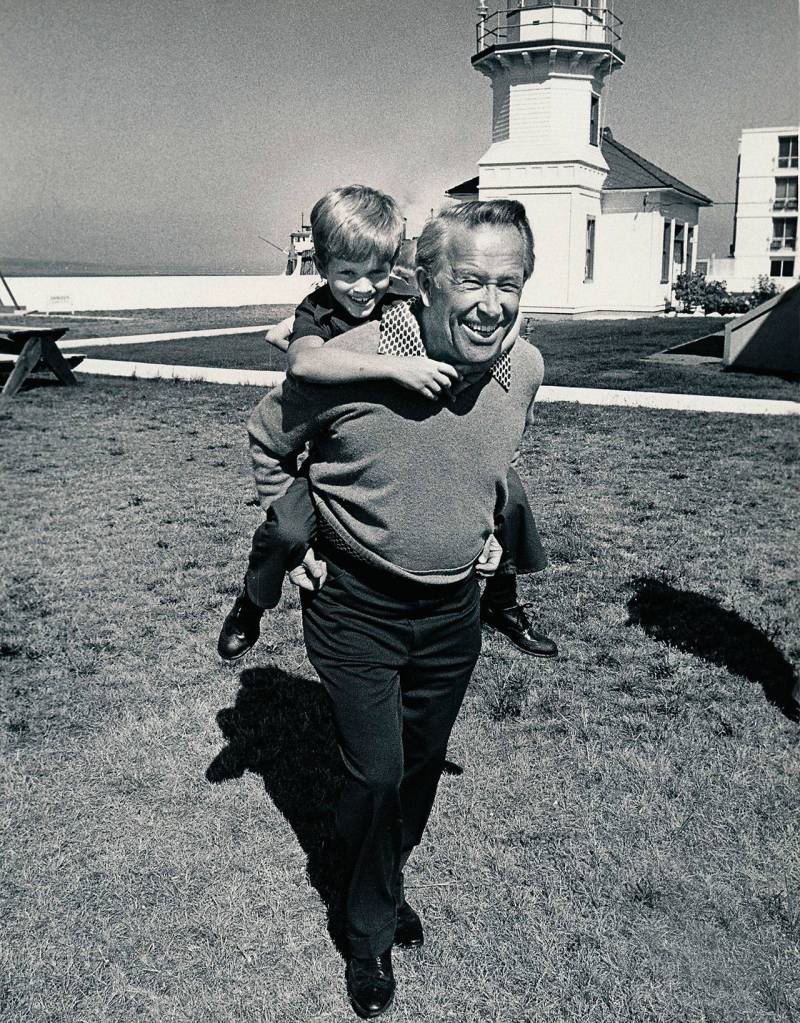 On a sunny day near Mukilteo Lighthouse Park, Peter enjoys a ride on his fathers back.