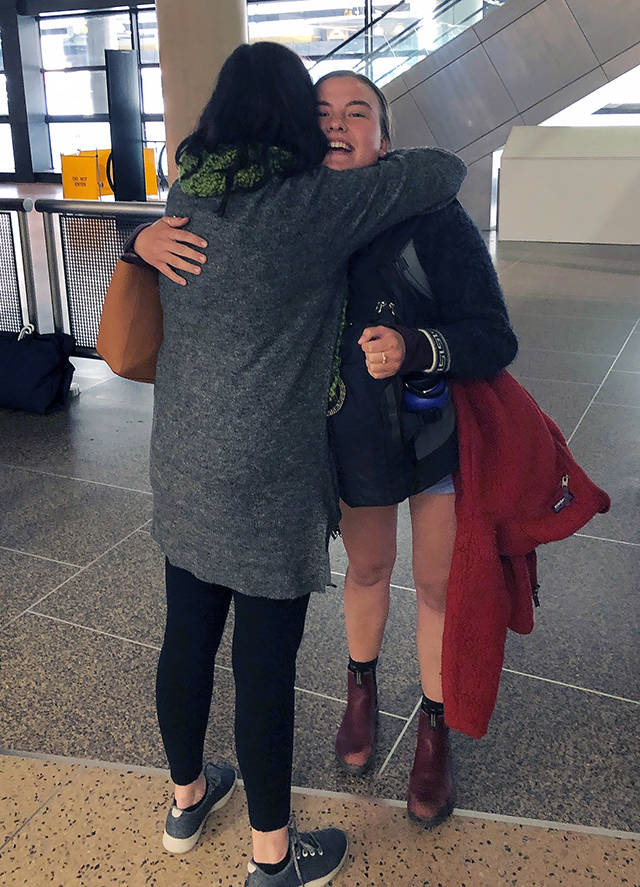 Caroline Overstreet (right) gets a hug from her mom, Jenny Overstreet, at Sea-Tac Airport recently after leaving Peru on the last flight to the United States before the South American country closed its borders due to COVID-19. (Courtesy Caroline Overstreet)