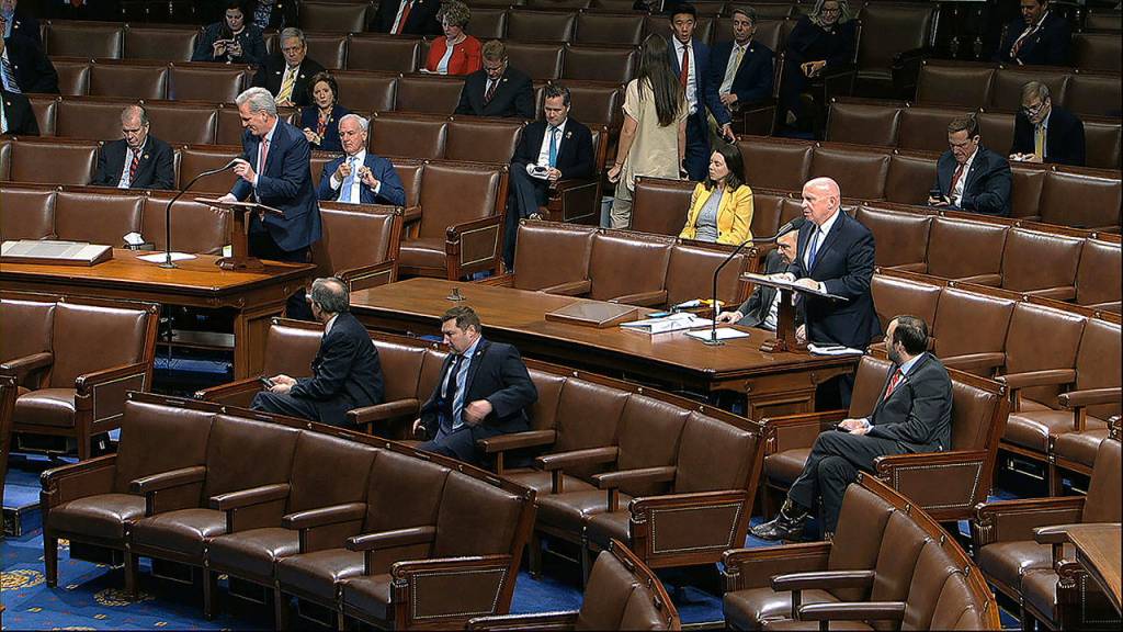 In this image from video, Rep. Kevin McCarthy, R-Texas (left) and Rep. Kevin Brady, R-Texas, stand as they speak on the floor of the House of Representatives at the U.S. Capitol in Washington on Friday. (House Television via AP)