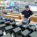 Greg GIlbert / The Seattle Times                                Kurt Miller prepares machines for shipment at Ventec Life Systems in Bothell last week.