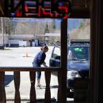 Dee Hatch delivers a food order to a waiting customer at Sky Deli in Skykomish, the last town on U.S. 2 before Stevens Pass. (Kevin Clark / The Herald)