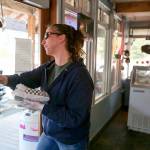 Dee Hatch delivers a food order to a waiting customer at Sky Deli. (Kevin Clark / The Herald)