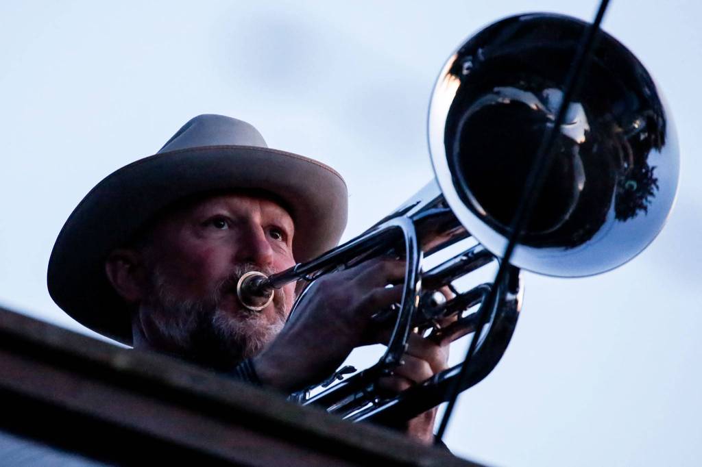 Kevin McKay plays Taps from his Everett home Wednesday  as he does every night, an apparently welcome sound to his neighbors in the Seahurst area. (Kevin Clark / The Herald)