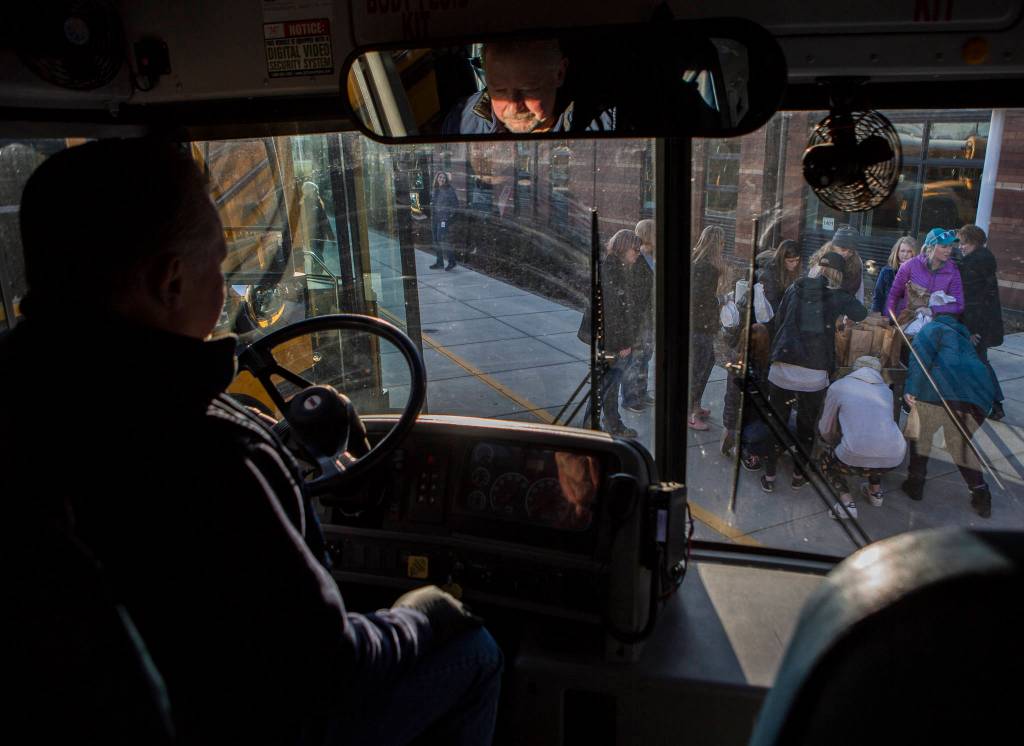 People gather to pick up special allergy meals before leaving Lakewood High School on March 18 in Marysville. (Olivia Vanni / The Herald)