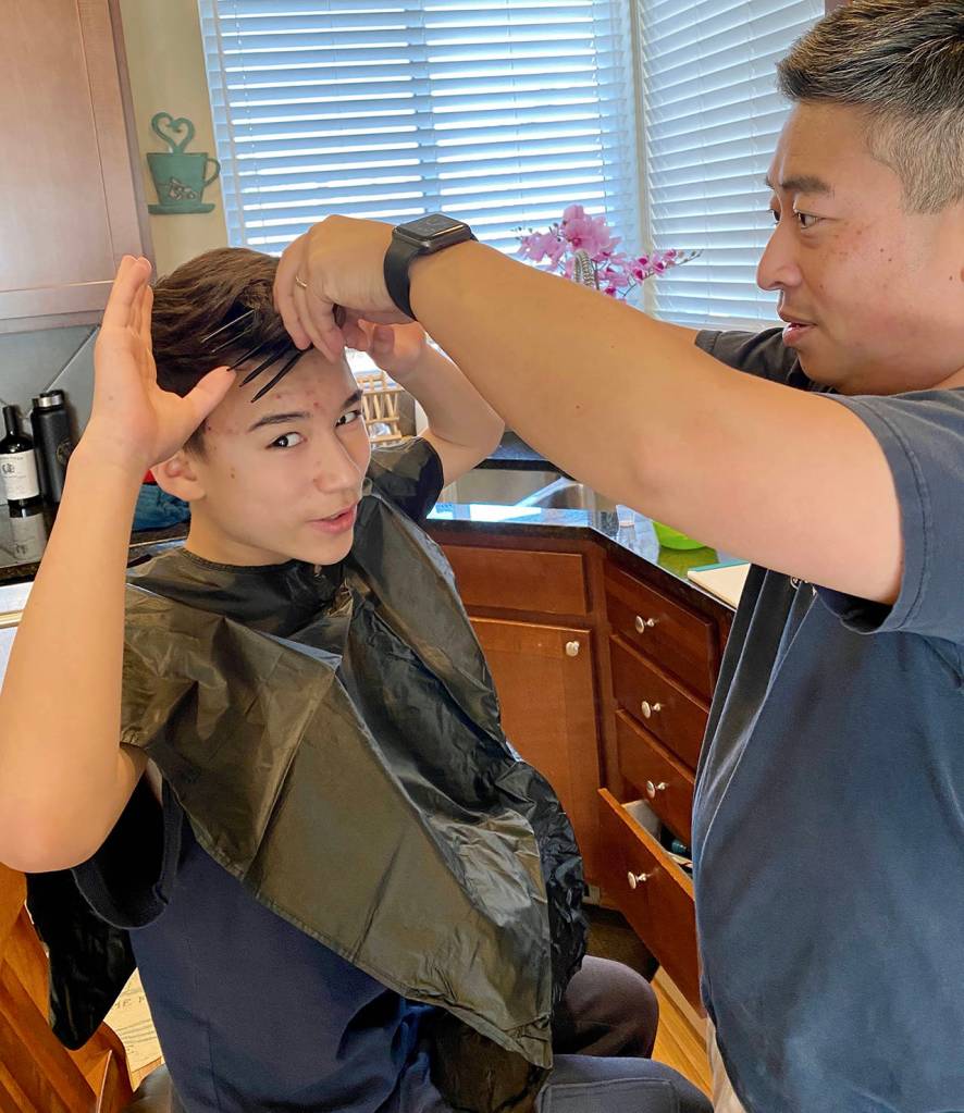Mukilteo Police Chief Cheol Kang gives his son Cooper, 13, a haircut in the kitchen. (Photo by Claire Kang)