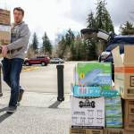 Keith Stefanson, Mukilteo School District facilities director, unloads personal protection equipment donated by the district on Wednesday at the Willis Tucker Park administration building in Snohomish. (Kevin Clark / The Herald)
