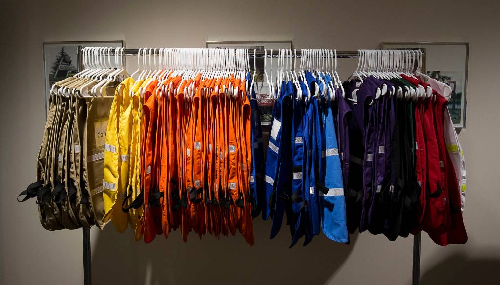 Color-coded vests hang on a rack at the Snohomish County Emergency Management Center on March 30 in Everett. (Andy Bronson / The Herald)