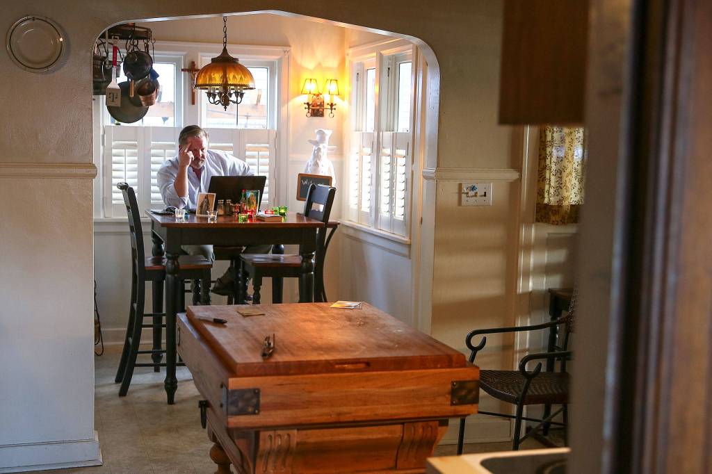 Jeffrey Morris watches Mass of the Lords Supper Livestream from St. James Cathedral in Seattle on Thursday. (Kevin Clark / The Herald)