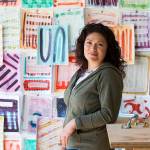 Artist Cat Snapp in her Everett studio on April 13, surrounded by her recent abstract works, including mixed-media on paper and small sculptures made of clay. (Andy Bronson / The Herald)