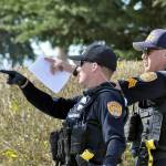 Police investigate a shooting at the corner of Rucker and Everett avenues Thursday afternoon. (Sue Misao / The Herald)