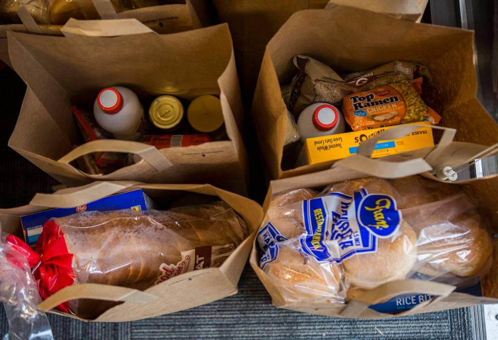 Bags for food sit near the entrance at The Village in Everett on April 21. (Olivia Vanni / The Herald)